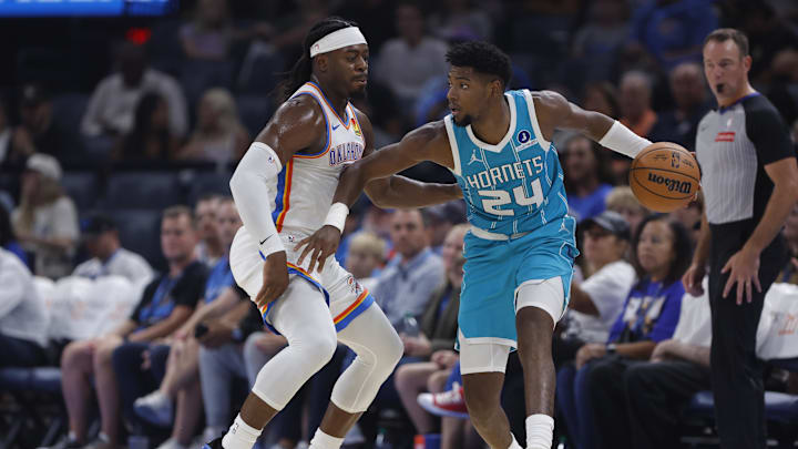 Oct 9, 2025; Oklahoma City, Oklahoma, USA; Charlotte Hornets forward Brandon Miller (24) moves the ball down the court as Oklahoma City Thunder guard Luguentz Dort (5) defends during the second quarter of a game between the Charlotte Hornets and the Oklahoma City Thunder at Paycom Center. Mandatory Credit: Alonzo Adams-Imagn Images