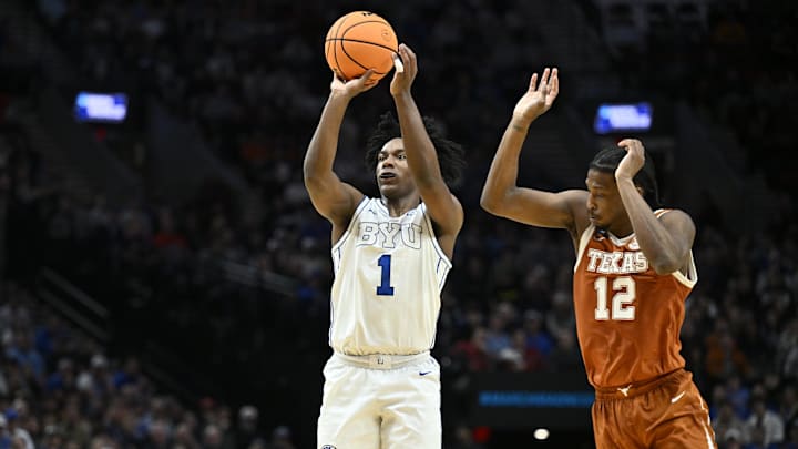 Mar 19, 2026; Portland, OR, USA; BYU Cougars guard Robert Wright III (1) shoots against Texas Longhorns guard Tramon Mark (12) in the first half during a first round game of the men's 2026 NCAA Tournament at Moda Center. Mandatory Credit: Craig Strobeck-Imagn Images
