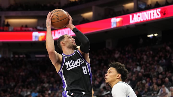 Mar 22, 2025; Sacramento, California, USA; Sacramento Kings guard Zach LaVine (8) shoots against Milwaukee Bucks guard Ryan Rollins (right) during the third quarter at Golden 1 Center. Mandatory Credit: Darren Yamashita-Imagn Images