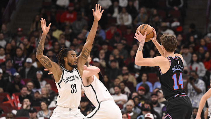 Dec 3, 2025; Chicago, Illinois, USA;  Brooklyn Nets center Nic Claxton (33) defends Chicago Bulls forward Matas Buzelis (14) during the second half at the United Center. Mandatory Credit: Matt Marton-Imagn Images