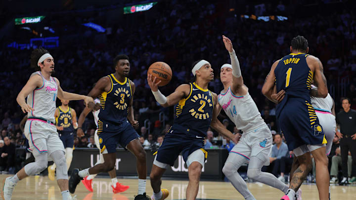 Feb 28, 2025; Miami, Florida, USA; Indiana Pacers guard Andrew Nembhard (2) drives to the basket against Miami Heat guard Tyler Herro (14) during the second quarter at Kaseya Center. Mandatory Credit: Sam Navarro-Imagn Images