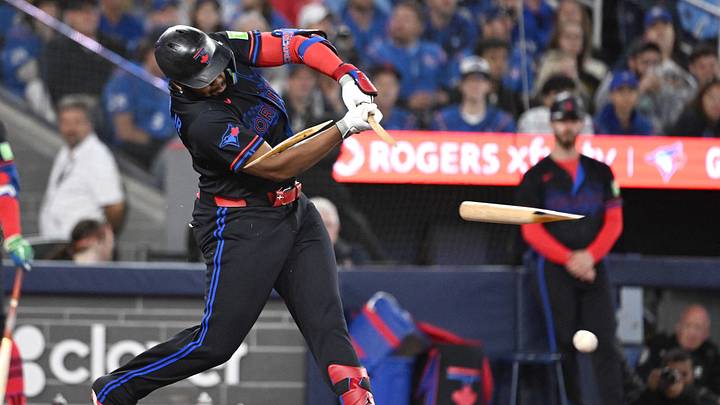 Sep 25, 2026; Toronto, Ontario, CAN;  Toronto Blue Jays first baseman Vladimir Guerrero Jr. (27) breaks his bat as he hits a single against the Cincinnati Reds in the seventh inning at Rogers Centre.  Mandatory Credit: Dan Hamilton-Imagn Images