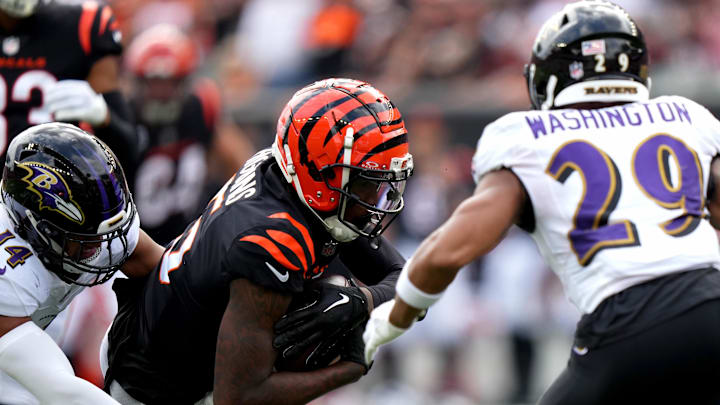 Sep 17, 2023; Cincinnati, Ohio, USA; Cincinnati Bengals wide receiver Tee Higgins (5) completes a catch as Baltimore Ravens safety Ar'Darius Washington (29) defends in the second quarter against the Baltimore Ravens at Paycor Stadium. Mandatory Credit: Albert Cesare-USA TODAY Sports