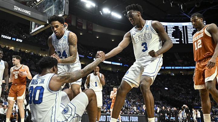 Mar 19, 2026; Portland, OR, USA; BYU Cougars guard Kennard Davis Jr. (30) is helped up by forward Dominique Diomande (24) and forward AJ Dybantsa (3) in the first half against the Texas Longhorns during a first round game of the men's 2026 NCAA Tournament at Moda Center. Mandatory Credit: Craig Strobeck-Imagn Images Mar 19, 2026; Portland, OR, USA; BYU Cougars guard Kennard Davis Jr. (30) is helped up by forward Dominique Diomande (24) and forward AJ Dybantsa (3) in the first half against the Texas Longhorns during a first round game of the men's 2026 NCAA Tournament at Moda Center. Mandatory Credit: Craig Strobeck-Imagn Images
