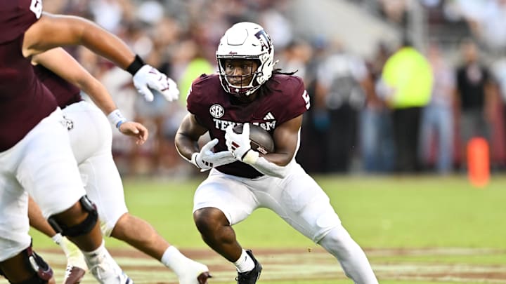 Aug 31, 2024; College Station, Texas, USA; Texas A&M Aggies running back Amari Daniels (5) runs the ball during the first quarter against the Notre Dame Fighting Irish at Kyle Field. Mandatory Credit: Maria Lysaker-Imagn Images