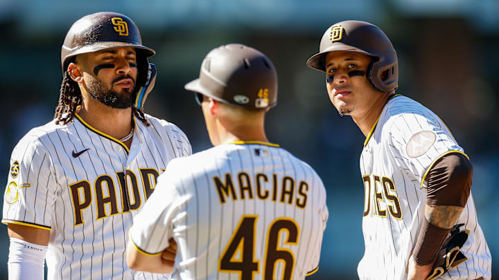 Mar 26, 2026; San Diego, California, USA; San Diego Padres right fielder Fernando Tatis Jr. (23) and third baseman Manny Machado (13) talk with San Diego first base coach David Macias (46) during the eighth inning against the Detroit Tigers at Petco Park. Mandatory Credit: David Frerker-Imagn Images Mar 26, 2026; San Diego, California, USA; San Diego Padres right fielder Fernando Tatis Jr. (23) and third baseman Manny Machado (13) talk with San Diego first base coach David Macias (46) during the eighth inning against the Detroit Tigers at Petco Park. Mandatory Credit: David Frerker-Imagn Images