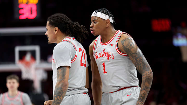 Feb 17, 2026; Columbus, Ohio, USA; Ohio State Buckeyes forward Amare Bynum (1) congratulates forward Devin Royal (21) during the first half against the Wisconsin Badgers at Value City Arena. Mandatory Credit: Joseph Maiorana-Imagn Images Feb 17, 2026; Columbus, Ohio, USA; Ohio State Buckeyes forward Amare Bynum (1) congratulates forward Devin Royal (21) during the first half against the Wisconsin Badgers at Value City Arena. Mandatory Credit: Joseph Maiorana-Imagn Images