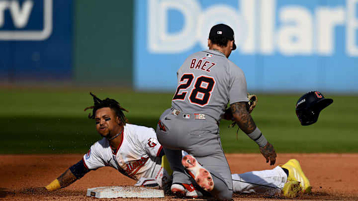 Oct 2, 2025; Cleveland, Ohio, USA; Detroit Tigers outfielder Javier Baez (28) tags out Cleveland Guardians third baseman Jose Ramirez (11) on an attempted steal in the fourth inning during game three of the Wildcard round for the 2025 MLB playoffs at Progressive Field. Mandatory Credit: Ken Blaze-Imagn Images