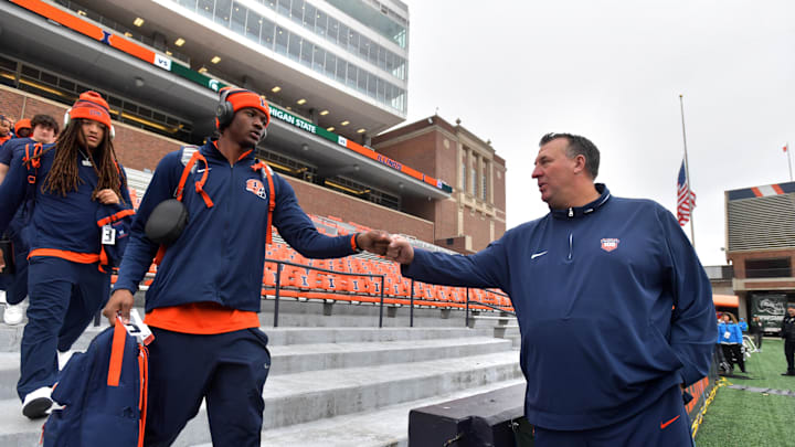 Nov 16, 2024; Champaign, Illinois, USA; Illinois Fighting Illini head coach Bret Bielema gives a hand to players before the game against the Michigan State Spartans at Memorial Stadium. Mandatory Credit: Ron Johnson-Imagn Images