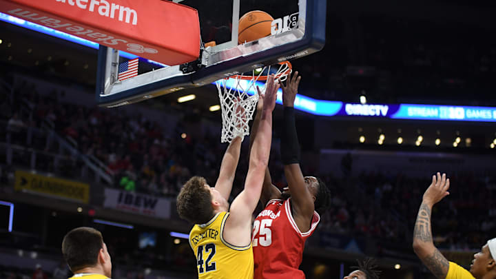 Mar 16, 2025; Indianapolis, IN, USA; Wisconsin Badgers guard John Blackwell (25) shoots a layup past Michigan Wolverines forward Will Tschetter (42) during the first half during the 2025 Big Ten Championship Game at Gainbridge Fieldhouse. Mandatory Credit: Robert Goddin-Imagn Images