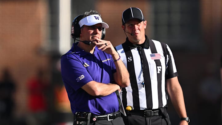 Oct 4, 2025; College Park, Maryland, USA;  Washington Huskies head coach Jedd Fisch talks with the field judge in the first half against the Maryland Terrapins at SECU Stadium. Mandatory Credit: Jamie Sabau-Imagn Images