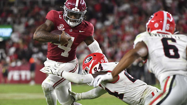 Sep 28, 2024; Tuscaloosa, Alabama, USA;  Georgia Bulldogs defensive back Malaki Starks (24) tackles Alabama Crimson Tide quarterback Jalen Milroe (4) at Bryant-Denny Stadium. Alabama defeated Georgia 41-34. Mandatory Credit: Gary Cosby Jr.-Imagn Images