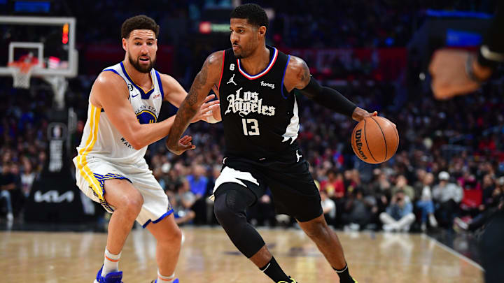 Mar 15, 2023; Los Angeles, California, USA; Los Angeles Clippers forward Paul George (13) moves the ball against Golden State Warriors guard Klay Thompson (11) during the second half at Crypto.com Arena. Mandatory Credit: Gary A. Vasquez-USA TODAY Sports