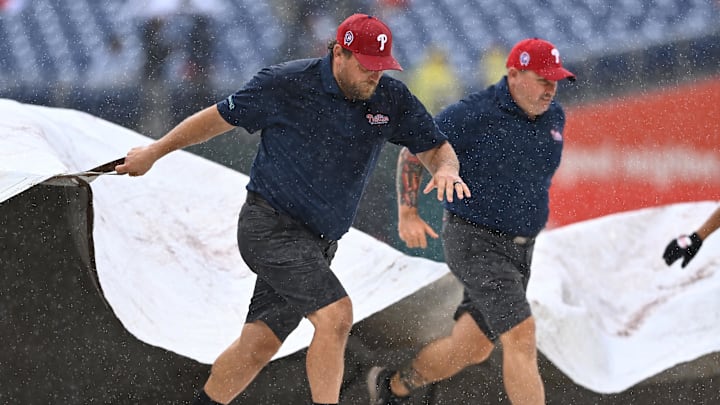 Phillies Grounds Crew cover the field during a rain delay
