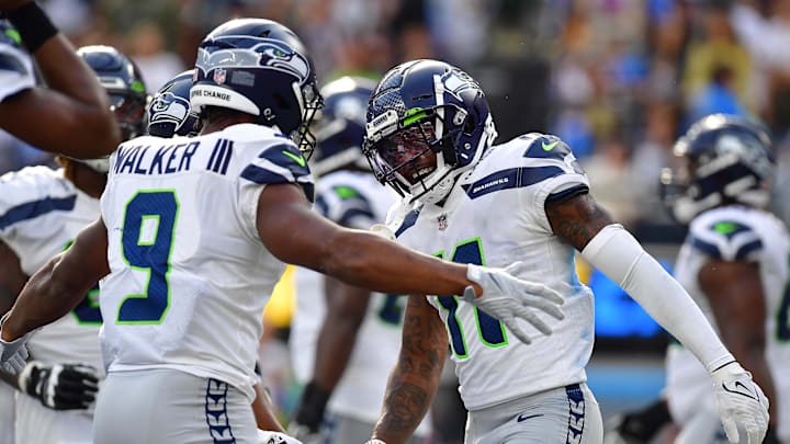 Seattle Seahawks wide receiver Marquise Goodwin celebrates with running back Kenneth Walker III, who's currently -110 to score an anytime TD.