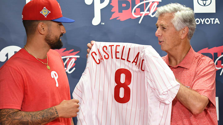 Mar 23, 2022; Clearwater, Florida, USA; Philadelphia Phillies president of baseball operations Dave Dombrowski gives outfielder Nick Castellanos (8) his new jersey before the start of the game against the Toronto Blue Jays during spring training at BayCare Ballpark. Mandatory Credit: Jonathan Dyer-Imagn Images