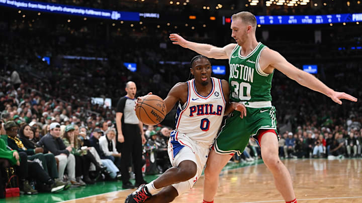 Dec 25, 2024; Boston, Massachusetts, USA; Philadelphia 76ers guard Tyrese Maxey (0) drives to the basket against Boston Celtics forward Sam Hauser (30)during the first half at TD Garden. Mandatory Credit: Eric Canha-Imagn Images