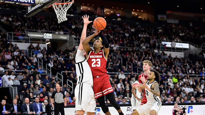 Nov 14, 2023; Providence, Rhode Island, USA; Wisconsin Badgers guard Chucky Hepburn (23) gets fouled by Providence Friars forward Josh Oduro (13) during the second half at Amica Mutual Pavilion.