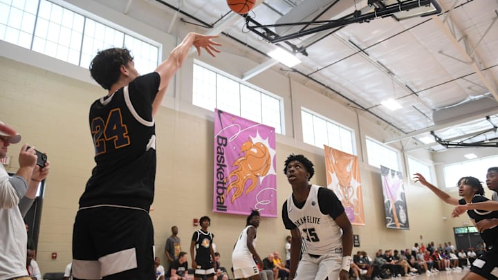 July 6, 2023; North Augusta, S.C., USA; Strive for Greatness Trent MacLean (24) passes the ball back in as Mokan Elite Xavier Wilson (35) defends during the Strive for Greatness and Mokan Elite basketball game at the fourth day of the Nike Peach Jam at Riverview Park Activities Center. Strive for Greatness defeated Mokan 63-54. Mandatory Credit: Katie Goodale-USA TODAY Network