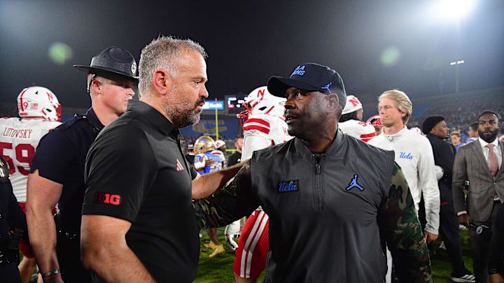 Nov 8, 2025; Pasadena, California, USA; Nebraska Cornhuskers head coach Matt Rhule meets with UCLA Bruins interim head coach Tim Skipper following the game at the Rose Bowl. Mandatory Credit: Gary A. Vasquez-Imagn Images