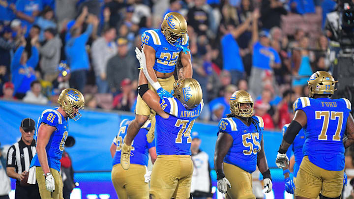 Nov 8, 2025; Pasadena, California, USA; UCLA Bruins running back Anthony Frias II (22) celebrates his touchdown scored against the Nebraska Cornhuskers with offensive lineman Julian Armella (74) during the second half at the Rose Bowl. Mandatory Credit: Gary A. Vasquez-Imagn Images
