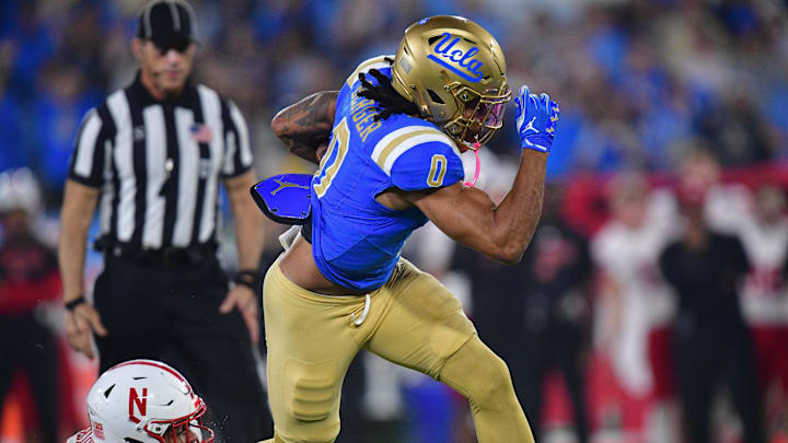 Nov 8, 2025; Pasadena, California, USA; UCLA Bruins running back Jalen Berger (0) runs the ball against Nebraska Cornhuskers linebacker Javin Wright (0) during the first half at the Rose Bowl. Mandatory Credit: Gary A. Vasquez-Imagn Images Nov 8, 2025; Pasadena, California, USA; UCLA Bruins running back Jalen Berger (0) runs the ball against Nebraska Cornhuskers linebacker Javin Wright (0) during the first half at the Rose Bowl. Mandatory Credit: Gary A. Vasquez-Imagn Images