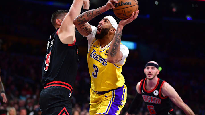 Jan 25, 2024; Los Angeles, California, USA; Los Angeles Lakers forward Anthony Davis (3) moves to the basket against Chicago Bulls center Nikola Vucevic (9) during the first half at Crypto.com Arena. Mandatory Credit: Gary A. Vasquez-Imagn Images
