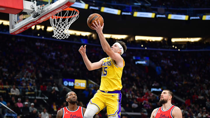 Feb 4, 2025; Inglewood, California, USA; Los Angeles Lakers guard Austin Reaves (15) scores a basket ahead of Los Angeles Clippers forward Kawhi Leonard (2) and center Ivica Zubac (40) during the second half at Intuit Dome. Mandatory Credit: Gary A. Vasquez-Imagn Images