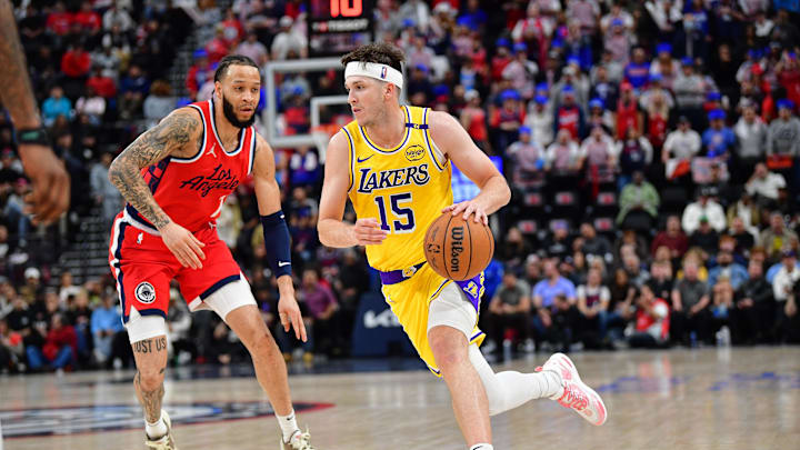 Feb 4, 2025; Inglewood, California, USA; Los Angeles Lakers guard Austin Reaves (15) moves the ball against Los Angeles Clippers guard Amir Coffey (7) during the second half at Intuit Dome. Mandatory Credit: Gary A. Vasquez-Imagn Images