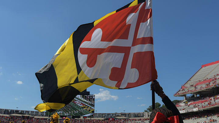 Sep 2, 2023; College Park, Maryland, USA; A member of the Maryland Terrapins spirit team holds a state flag before the game against the Towson Tigers  at SECU Stadium. Mandatory Credit: Tommy Gilligan-Imagn Images