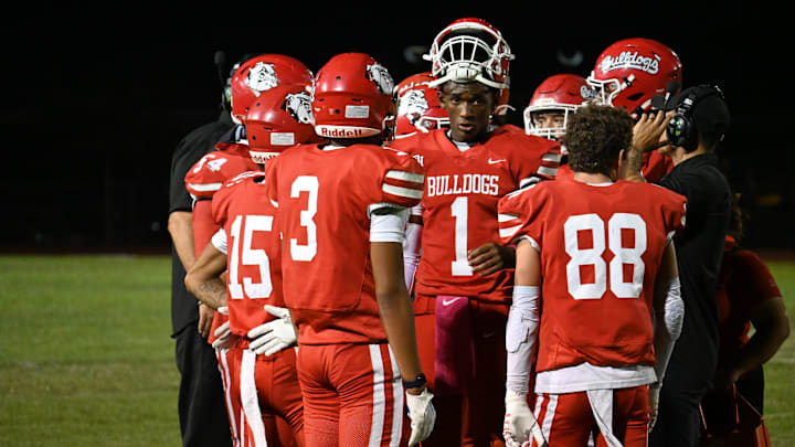 Oak Hills quarterback Jacob Webster talks to his teammates during a timeout on Thursday, Oct. 3, 2024. Oak Hills kicked off Mojave River League play with a 34-0 victory over Hesperia.