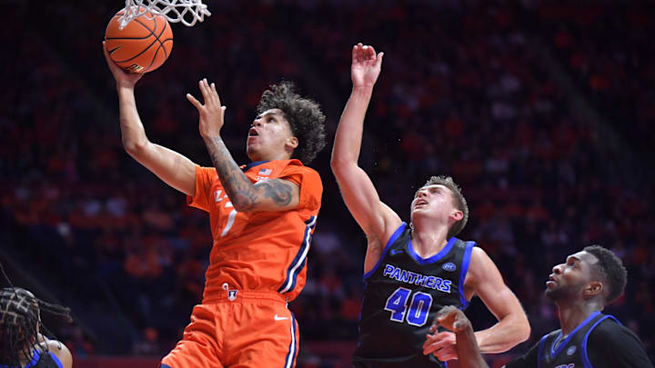Nov 4, 2024; Champaign, Illinois, USA;  Illinois Fighting Illini forward Will Riley (7) drives past Eastern Illinois Panthers forward Cooper Jacobi (40) during the first half at State Farm Center. Mandatory Credit: Ron Johnson-Imagn Images
