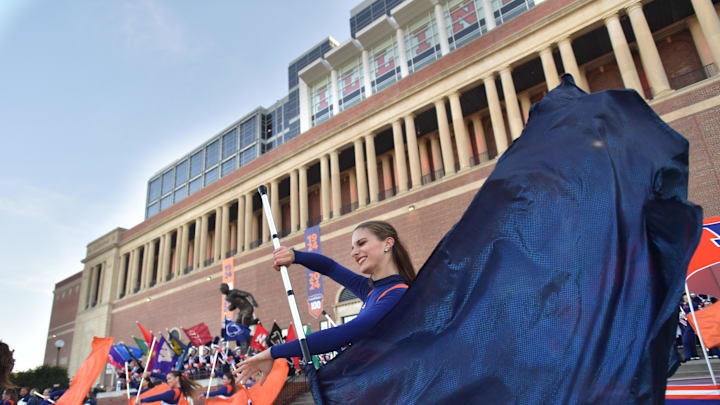 Nov 2, 2024; Champaign, Illinois, USA;  Members of the Marching Illini Band perform outside the stadium before the start of a game with the Minnesota Golden Gophers at Memorial Stadium. Mandatory Credit: Ron Johnson-Imagn Images