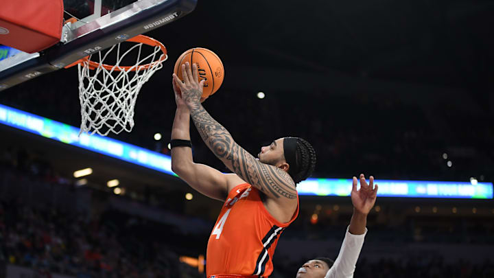 Mar 14, 2025; Indianapolis, IN, USA; Illinois Fighting Illini guard Kylan Boswell (4) scores past Maryland Terrapins center Derik Queen (25) during the second half at Gainbridge Fieldhouse. Mandatory Credit: Robert Goddin-Imagn Images