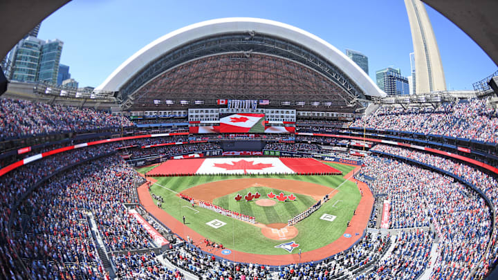 A Canadian flag is brought onto the field for Canada Day opening ceremonies.