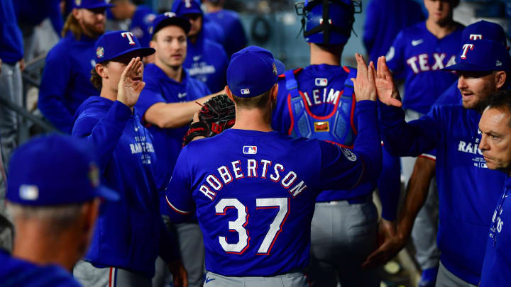 Jun 12, 2024; Los Angeles, California, USA; Texas Rangers pitcher David Robertson (37) is greeted following the eighth inning against the Los Angeles Dodgers at Dodger Stadium. Mandatory Credit: Gary A. Vasquez-USA TODAY Sports
