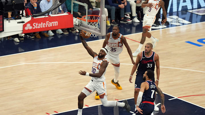 Oct 23, 2024; Inglewood, California, USA; Phoenix Suns forward Royce O'Neale (00) shoots the ball against LA Clippers guard Amir Coffey (7) and forward Nicolas Batum (33) in the first half at Intuit Dome. Mandatory Credit: Kirby Lee-Imagn Images Oct 23, 2024; Inglewood, California, USA; Phoenix Suns forward Royce O'Neale (00) shoots the ball against LA Clippers guard Amir Coffey (7) and forward Nicolas Batum (33) in the first half at Intuit Dome. Mandatory Credit: Kirby Lee-Imagn Images