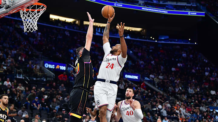 Oct 31, 2024; Inglewood, California, USA; Los Angeles Clippers guard Norman Powell (24) shoots against Phoenix Suns center Jusuf Nurkic (20) during the second half at Intuit Dome. Mandatory Credit: Gary A. Vasquez-Imagn Images