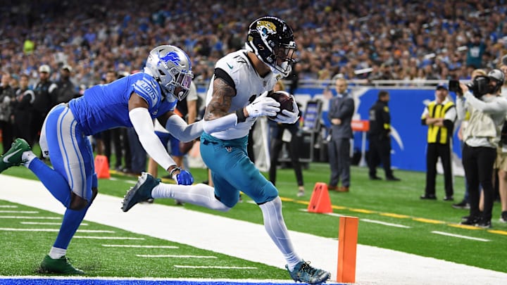 Dec 4, 2022; Detroit, Michigan, USA; Jacksonville Jaguars tight end Evan Engram (17) catches a touchdown pass from quarterback Trevor Lawrence (not pictured) against Detroit Lions cornerback Jeff Okudah (1) in the third quarter at Ford Field. Mandatory Credit: Lon Horwedel-Imagn Images