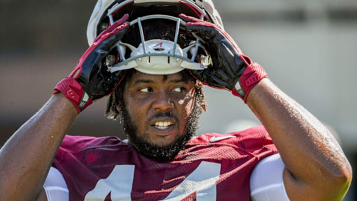 The Crimson Tide players and coaches continue working toward the season opener in practice Tuesday, Aug. 13, 2024. Alabama defensive lineman Damon Payne Jr. (44) takes a break.