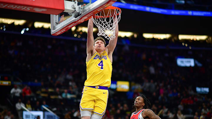 Feb 4, 2025; Inglewood, California, USA; Los Angeles Lakers guard Dalton Knecht (4) dunks for the basket against the Los Angeles Clippers during the second half at Intuit Dome. Mandatory Credit: Gary A. Vasquez-Imagn Images