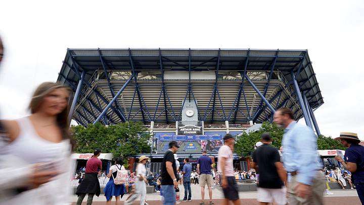 Aug 28, 2023; Flushing, NY, USA; Fans walk in front of Arthur Ashe Stadium on day one of the 2023 U.S. Open at the Billie Jean King National Tennis Center. Mandatory Credit: Danielle Parhizkaran-USA TODAY Sports
