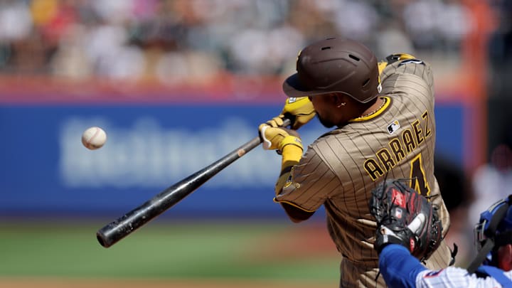 Sep 18, 2025; New York City, New York, USA; San Diego Padres second baseman Luis Arraez (4) hits an RBI sacrifice fly against the New York Mets during the third inning at Citi Field. Mandatory Credit: Brad Penner-Imagn Images