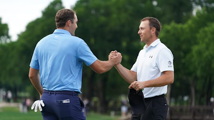 Scottie Scheffler and Jordan Spieth shake hands on the ninth green following their second round of the THE CJ CUP Byron Nelson golf tournament. 