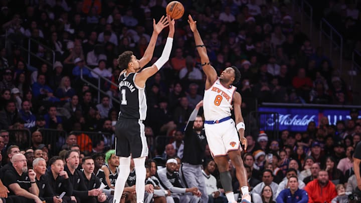 Dec 25, 2024; New York, New York, USA;  San Antonio Spurs center Victor Wembanyama (1) takes a three point shot past New York Knicks forward OG Anunoby (8) in the fourth quarter at Madison Square Garden. Mandatory Credit: Wendell Cruz-Imagn Images
