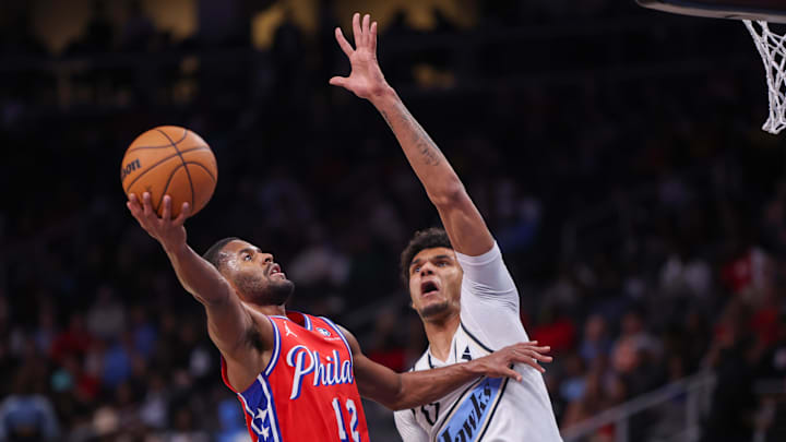 Mar 23, 2025; Atlanta, Georgia, USA; Philadelphia 76ers guard Jared Butler (12) shoots past Atlanta Hawks forward Dominick Barlow (0) in the second quarter at State Farm Arena. Mandatory Credit: Brett Davis-Imagn Images Mar 23, 2025; Atlanta, Georgia, USA; Philadelphia 76ers guard Jared Butler (12) shoots past Atlanta Hawks forward Dominick Barlow (0) in the second quarter at State Farm Arena. Mandatory Credit: Brett Davis-Imagn Images