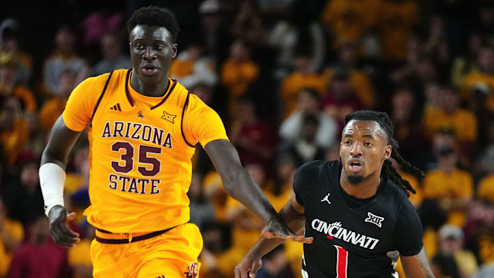 Cincinnati guard Day Day Thomas (1) drives up the court against Arizona State center Massamba Diop (35) during a game at Desert Financial Arena in Tempe, Ariz., on Jan. 24, 2026.