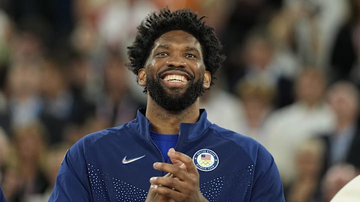United States centre Joel Embiid (11) celebrates with the gold medal after the game against France in the men's basketball gold medal game during the Paris 2024 Olympic Summer Games at Accor Arena on Aug 10.