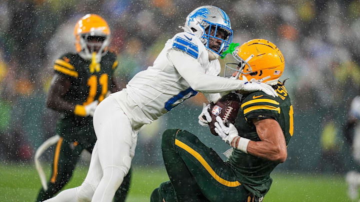 Detroit Lions cornerback Terrion Arnold (0) tackles Green Bay Packers wide receiver Christian Watson (9) during the second half at Lambeau Field in Green Bay, Wis. on Sunday, Nov. 3, 2024.