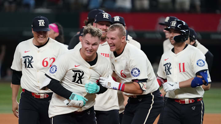 Aug 22, 2025; Arlington, Texas, USA; Texas Rangers first baseman Joc Pederson (4) celebrates his walk off ninth inning RBI double with third baseman Josh Jung (6) during a game against the Cleveland Guardians at Globe Life Field. 